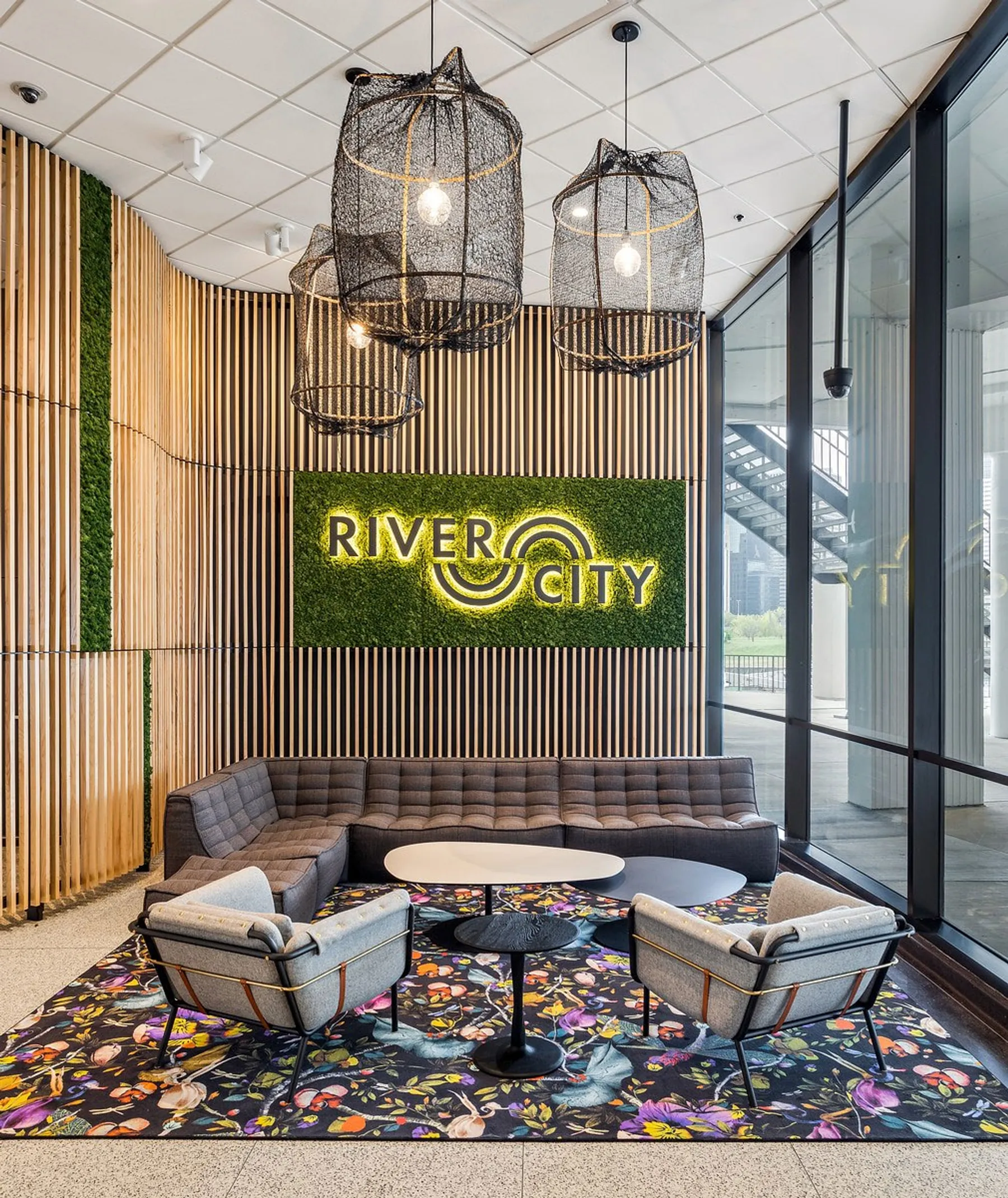 custom branding with laser cut steel and ash slat wall with plants by Icon Modern