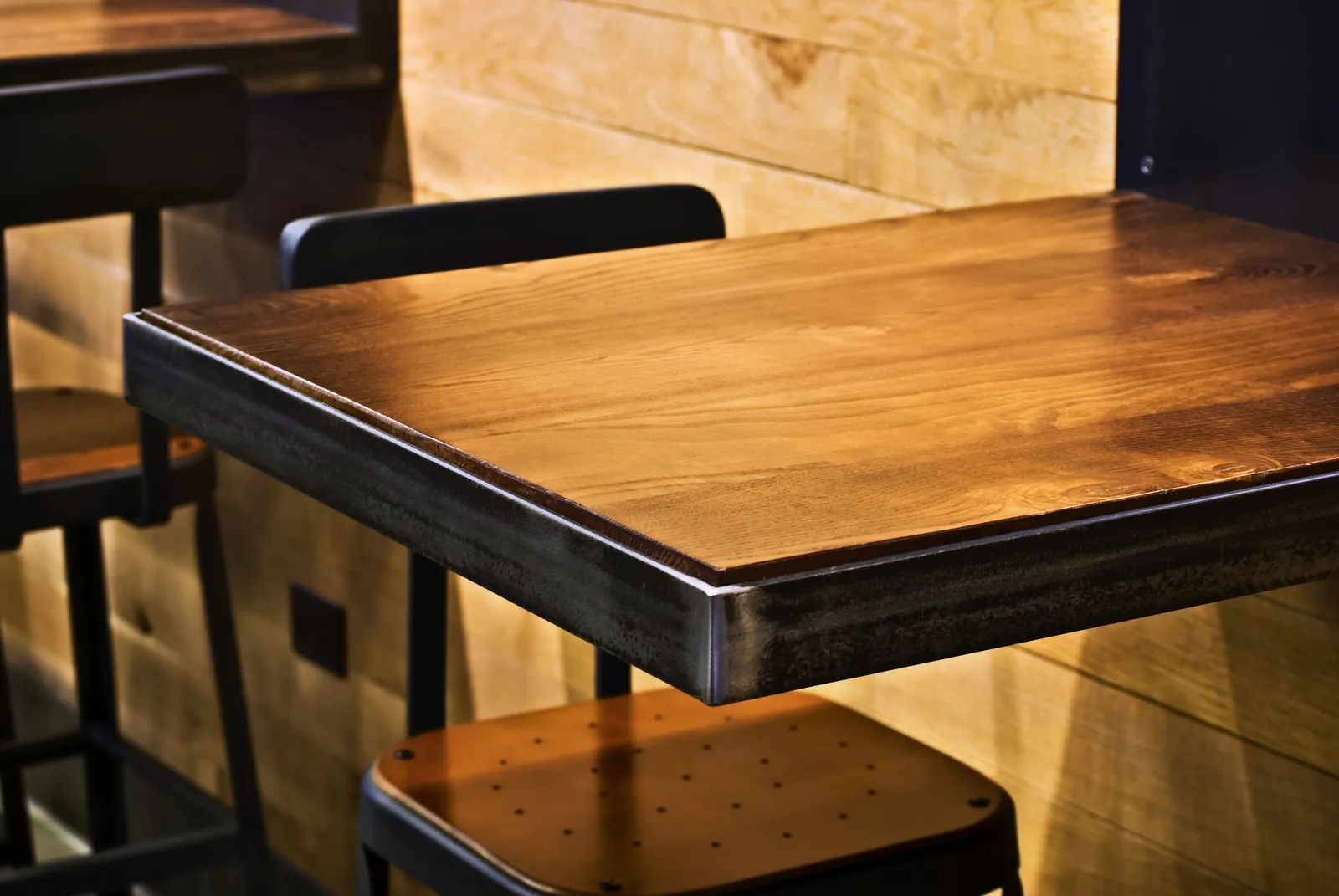 custom cafe table in urban ash custom finish w/ steel edge banding by Icon Modern