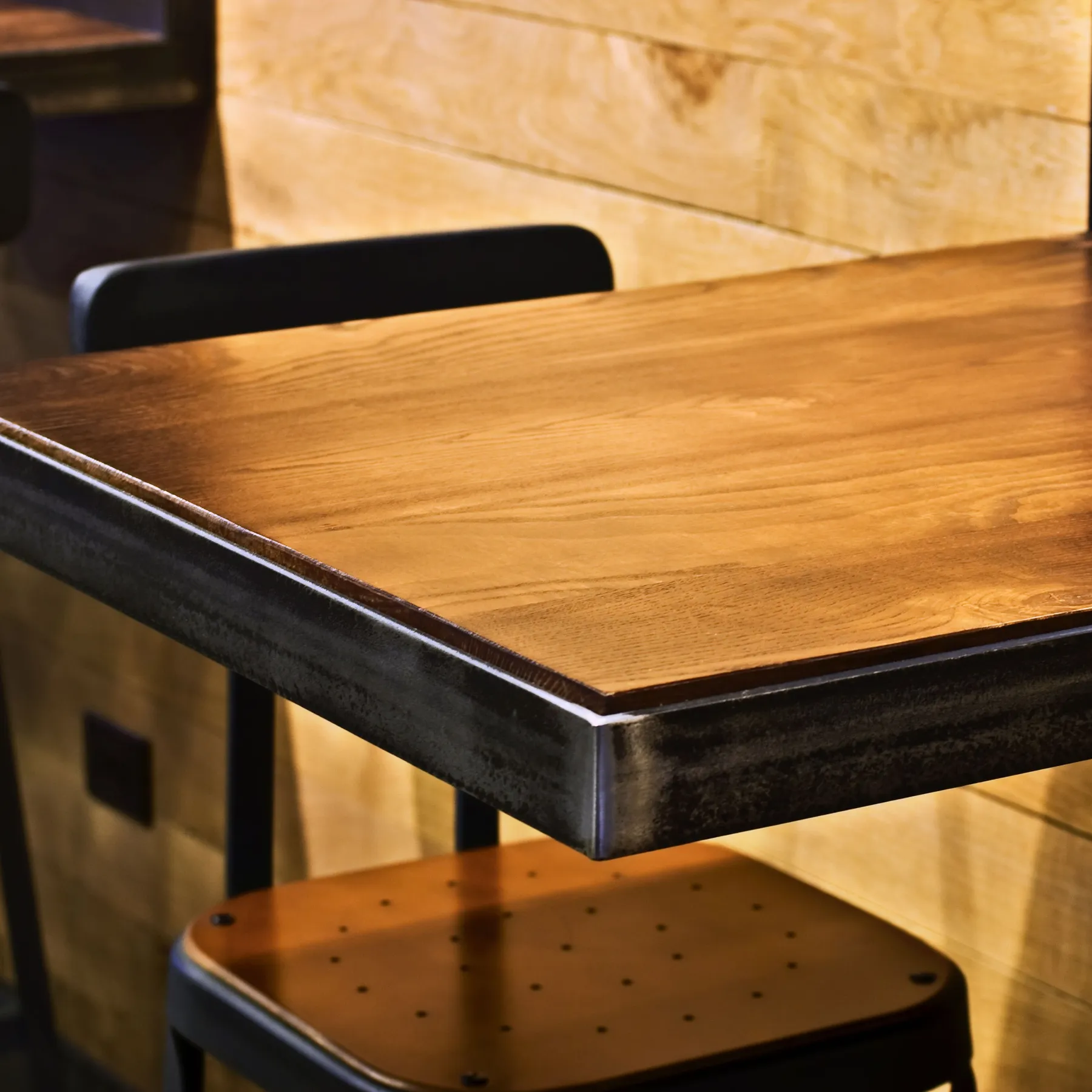 custom cafe table in urban ash custom finish w/ steel edge banding by Icon Modern