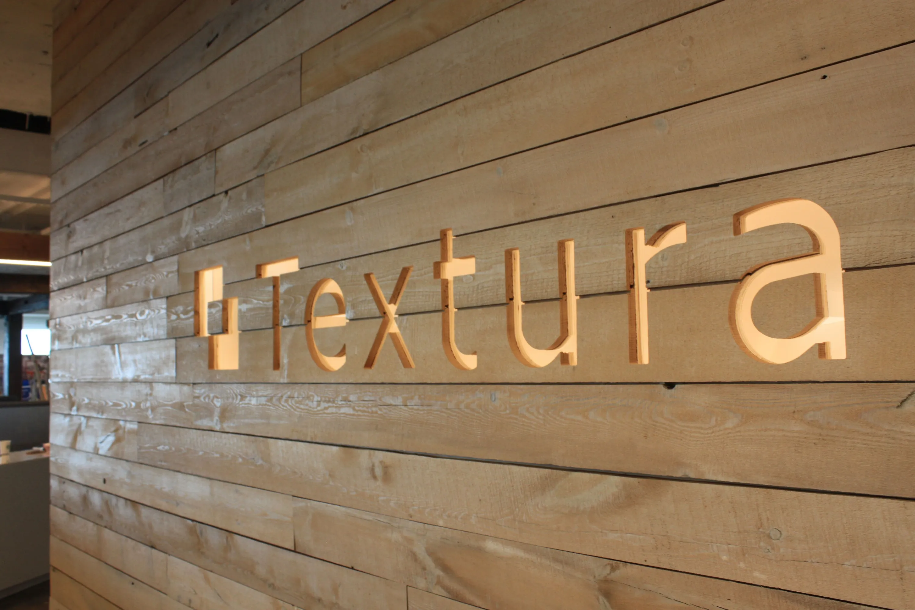 custom cladding in old growth fir whitewash with CNC branding by Icon Modern