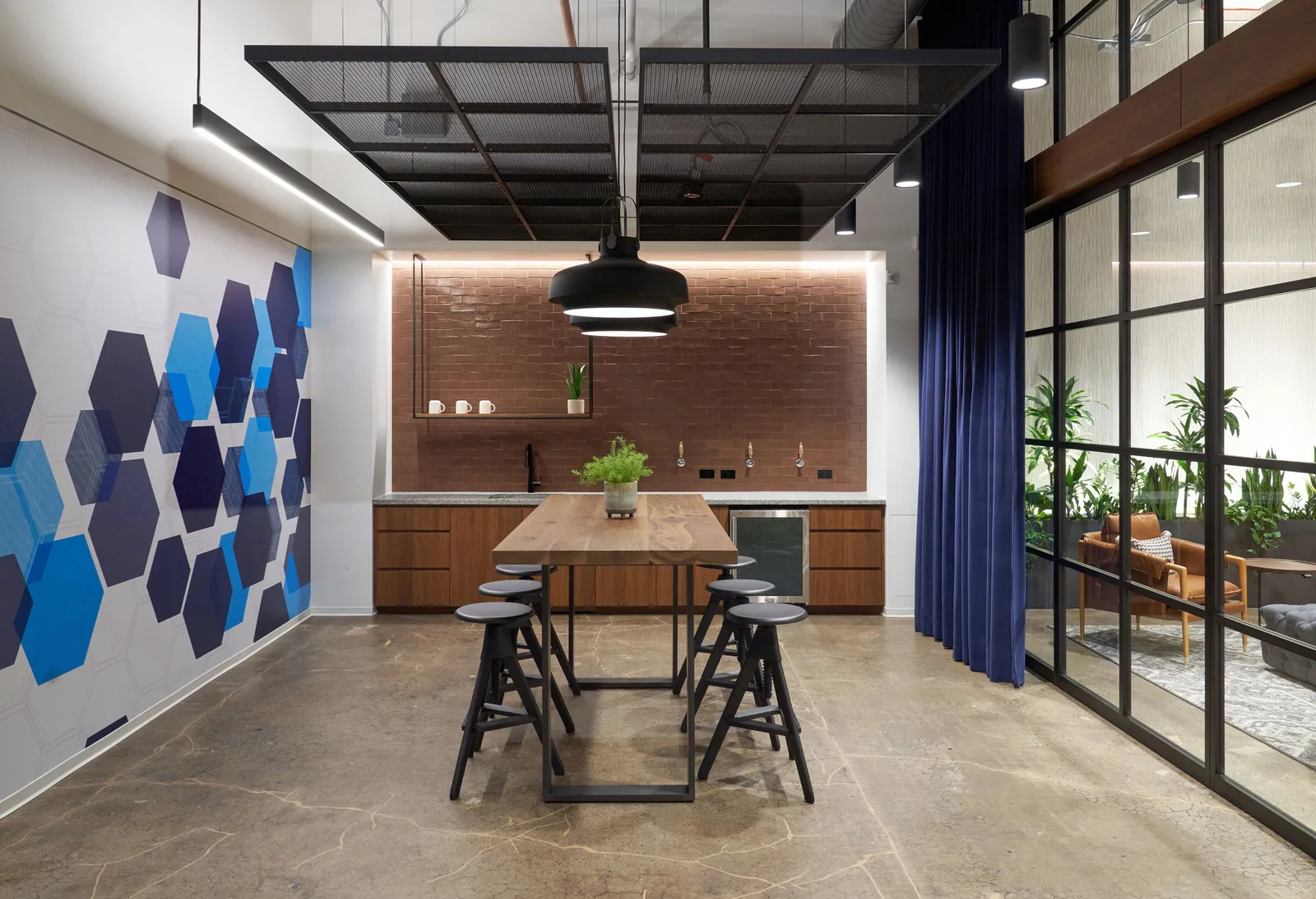 custom walnut table with steel strap base and steel ceiling panels by Icon Modern