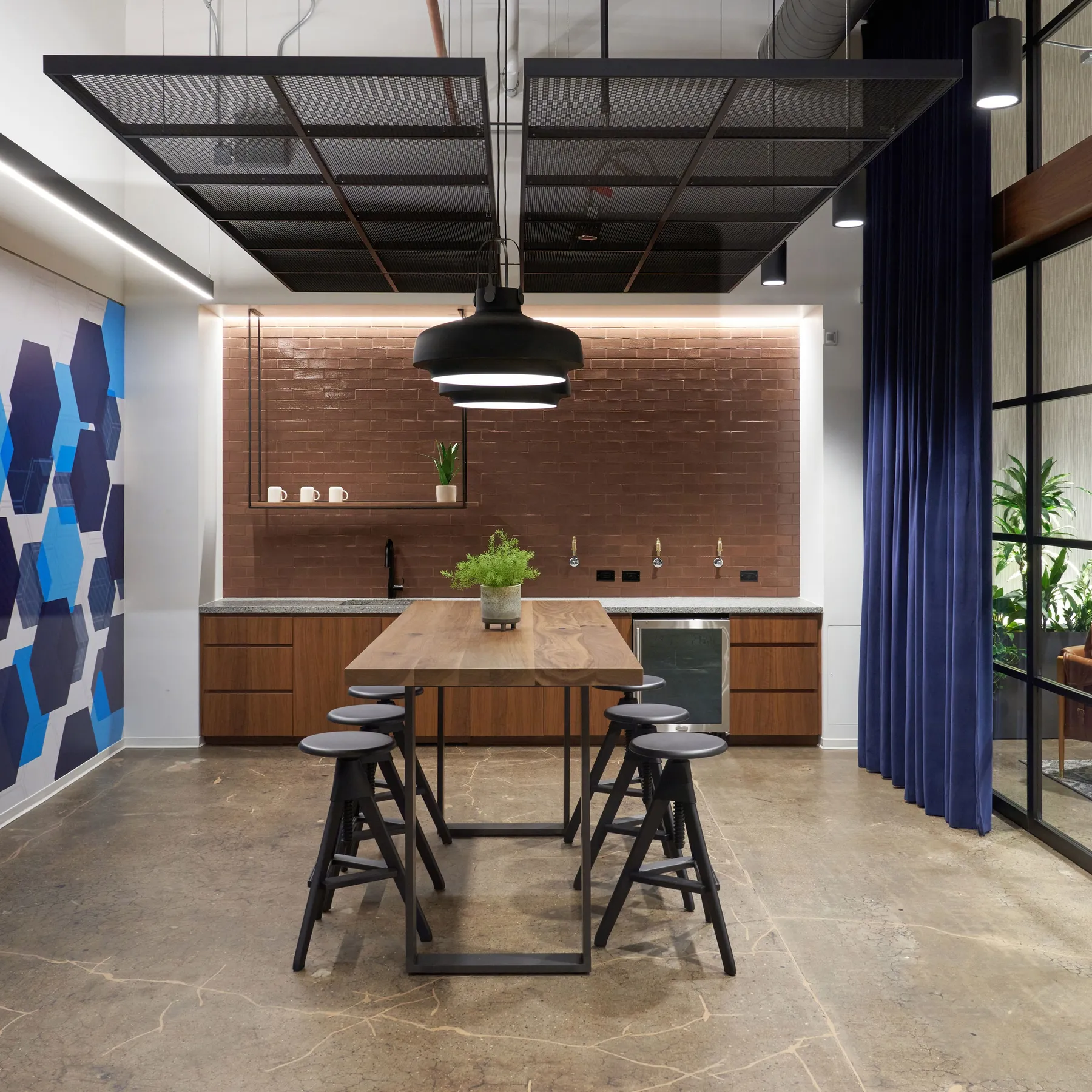 custom walnut table with steel strap base and steel ceiling panels by Icon Modern