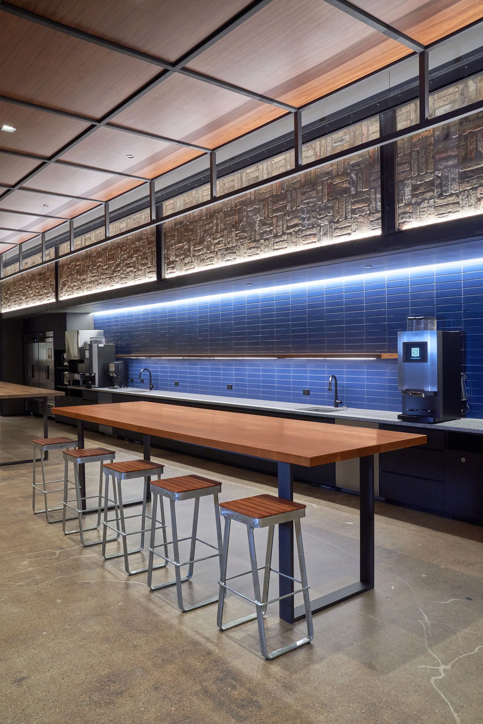 custom walnut table with steel strap base and steel ceiling/wall elements by Icon Modern