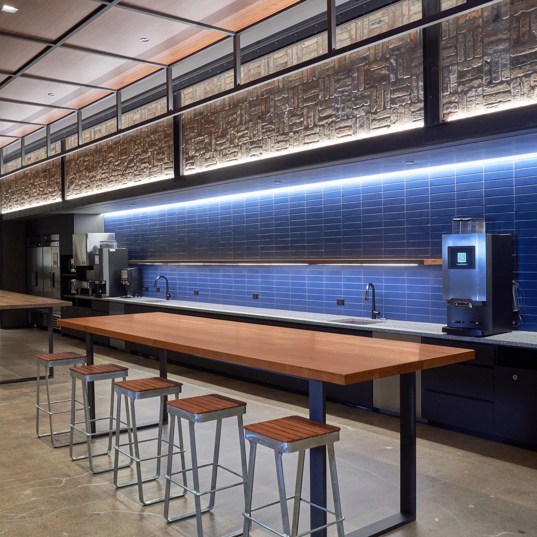 custom walnut table with steel strap base and steel ceiling/wall elements by Icon Modern