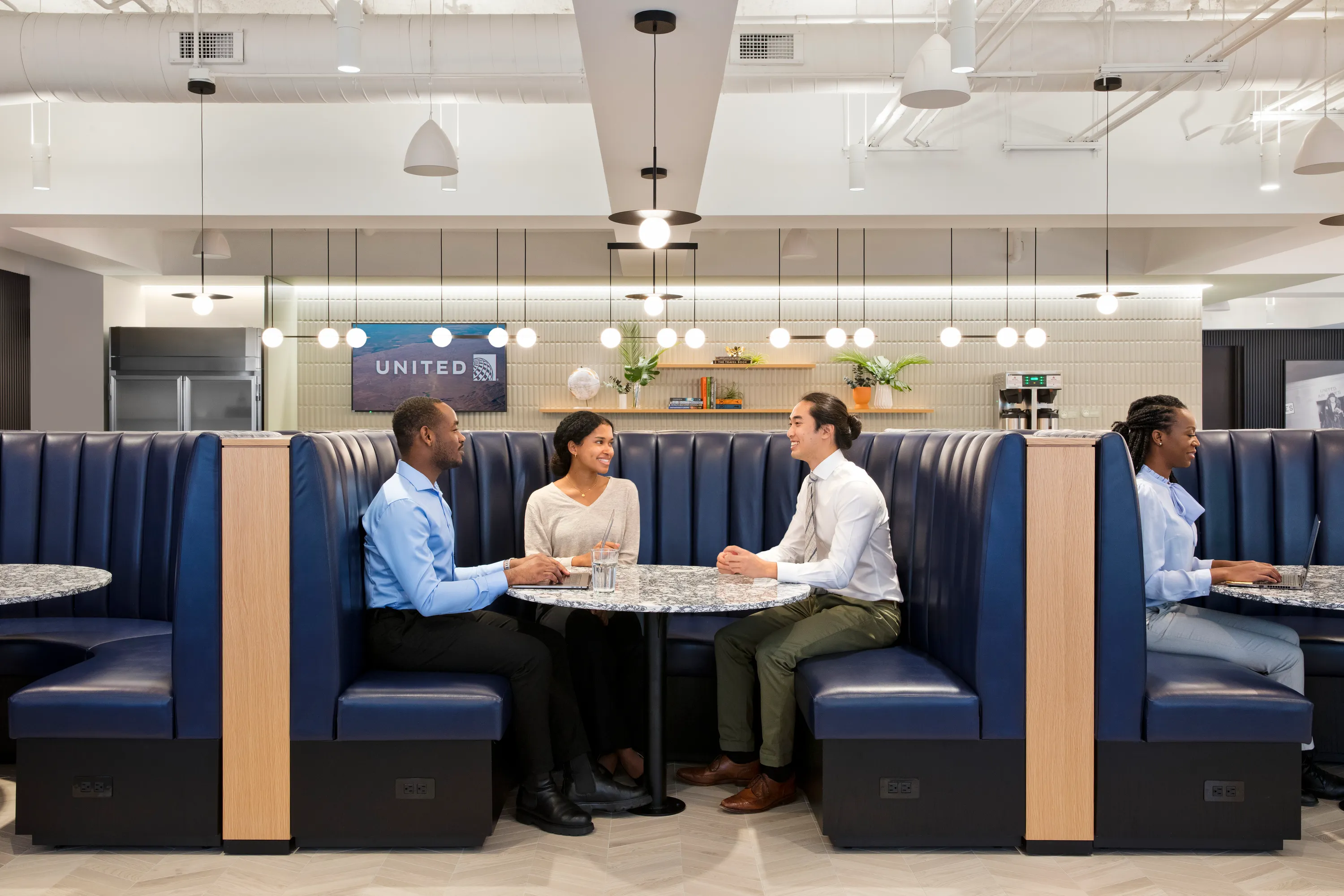 custom stone cafe table and wood veneer banquette by Icon MOdern