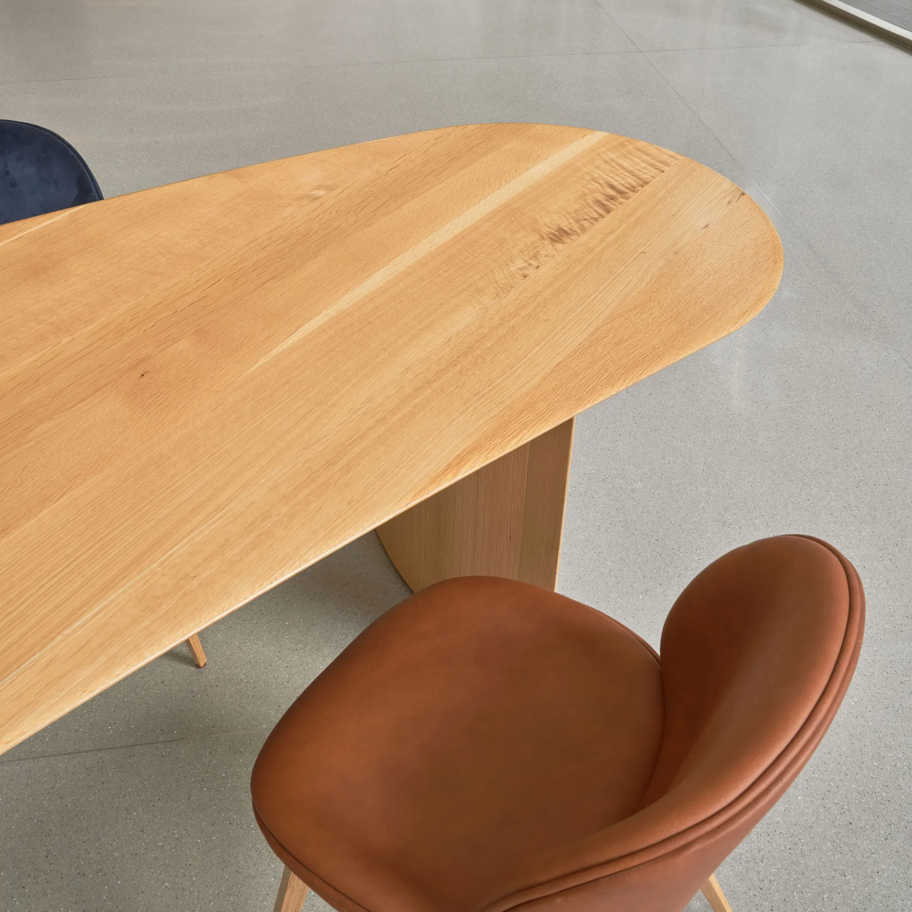 custom community table in urban oak detail by Icon Modern