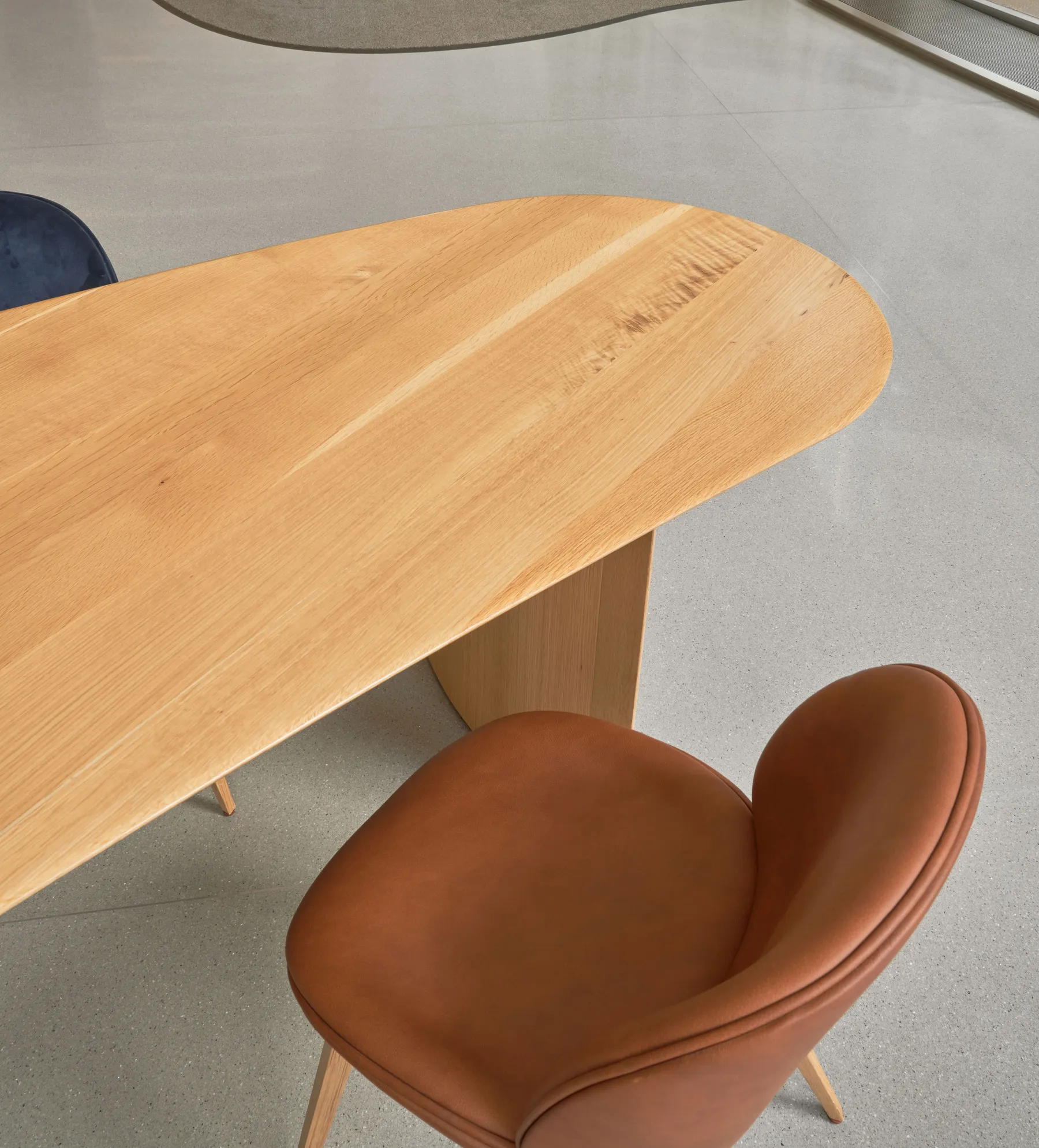 custom community table in urban oak detail by Icon Modern