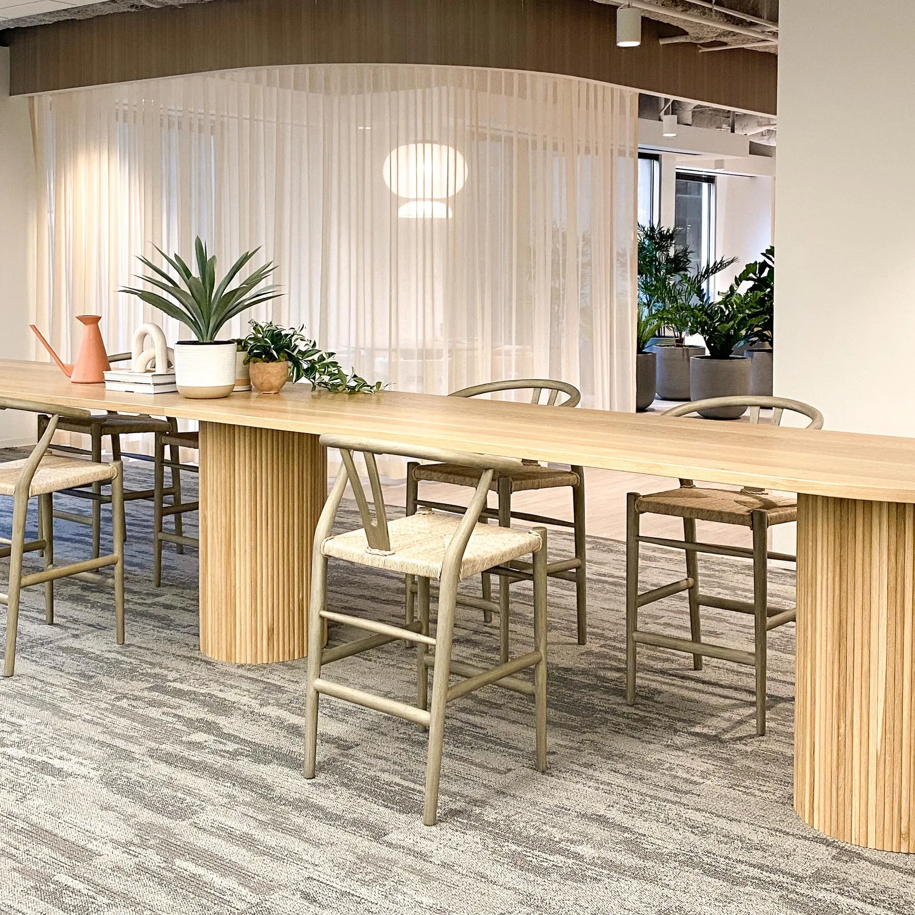 custom community table in urban oak with an oak tambour base by Icon Modern